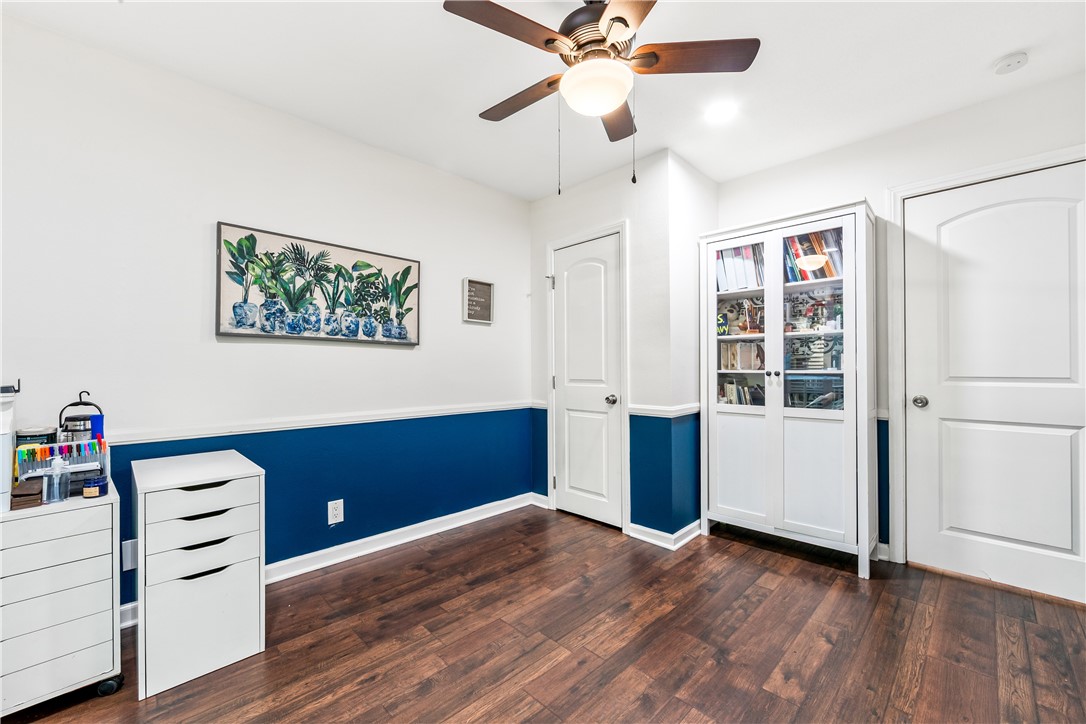 7890 East Spring Street, Unit 22F Long Beach, CA 90815 - Photo 41 of 60 a view of workspace with wooden floor and ceiling fan