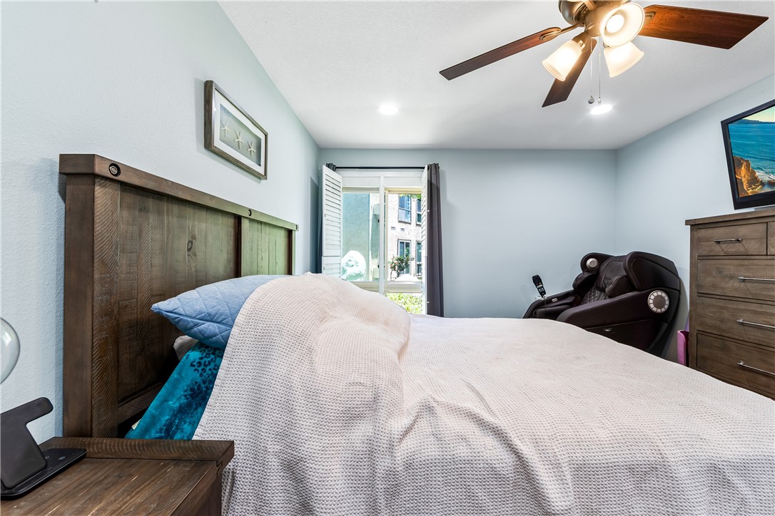 7890 East Spring Street, Unit 22F Long Beach, CA 90815 - Photo 48 of 60 a bedroom with a bed and a chandelier