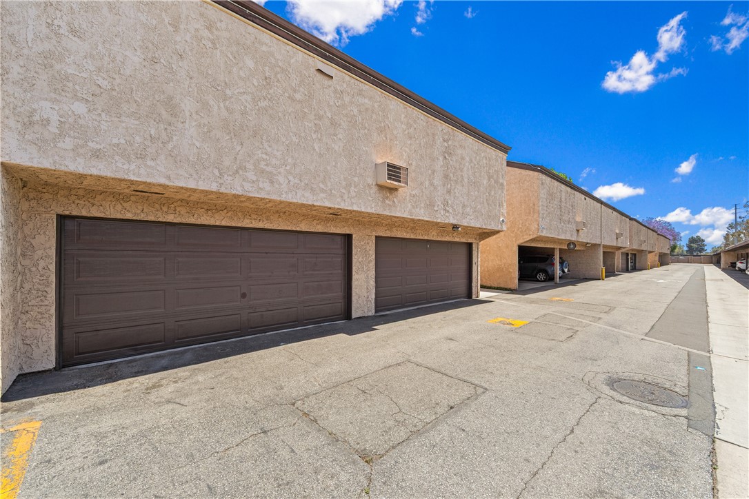 7890 East Spring Street, Unit 22F Long Beach, CA 90815 - Photo 53 of 60 a front view of a house with a garage