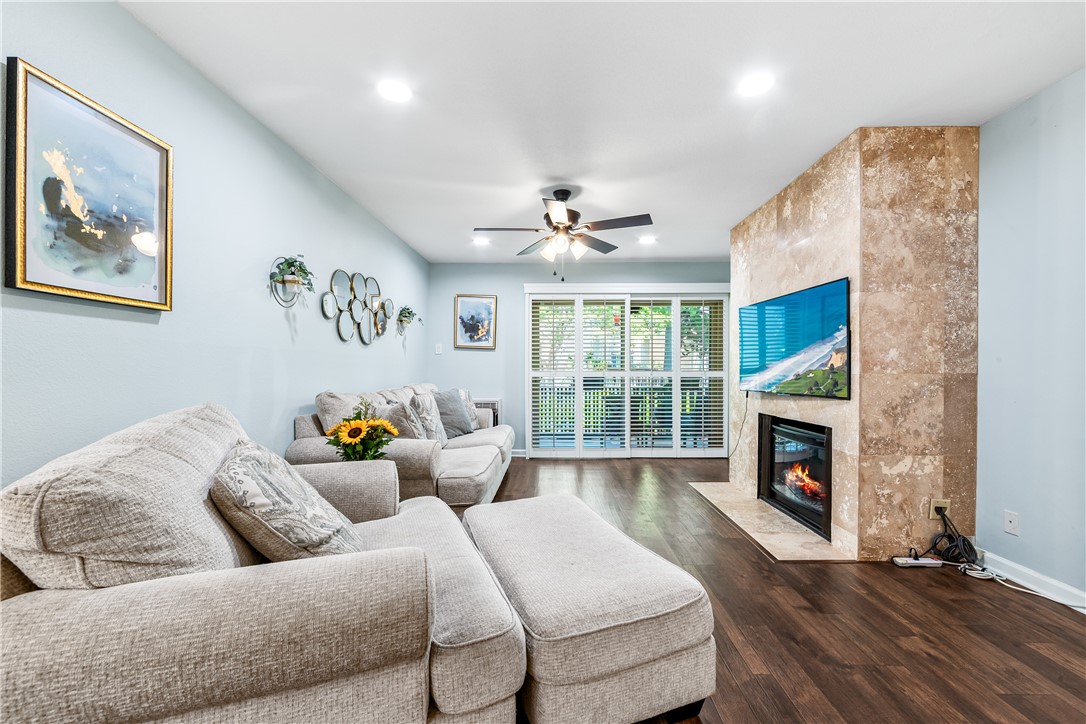 7890 East Spring Street, Unit 22F Long Beach, CA 90815 - Photo 6 of 60 a living room with furniture and a fireplace