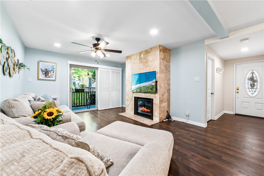 7890 East Spring Street, Unit 22F Long Beach, CA 90815 - Photo 10 of 35 a bedroom with furniture and a fireplace