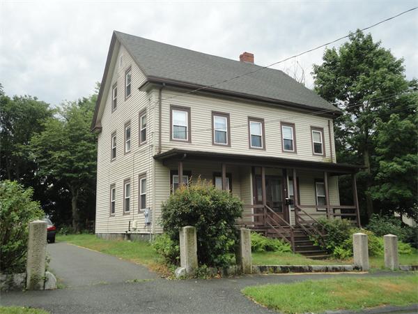 6 Eaton Street Wakefield, MA 01880 - Photo 2 of 11 a front view of a house with a yard