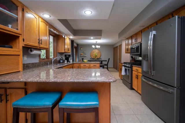 a large kitchen with stainless steel appliances granite countertop a large counter top
