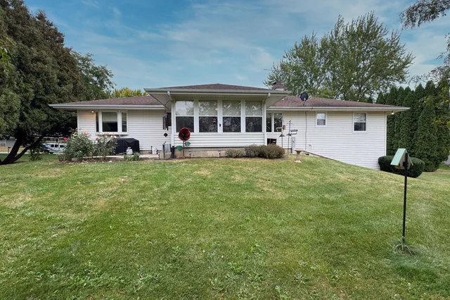 a house view with a sitting space and garden