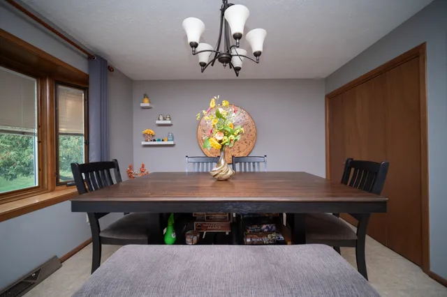 a view of a dining room with furniture and window
