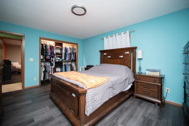 a bed sitting in a bedroom next to a window