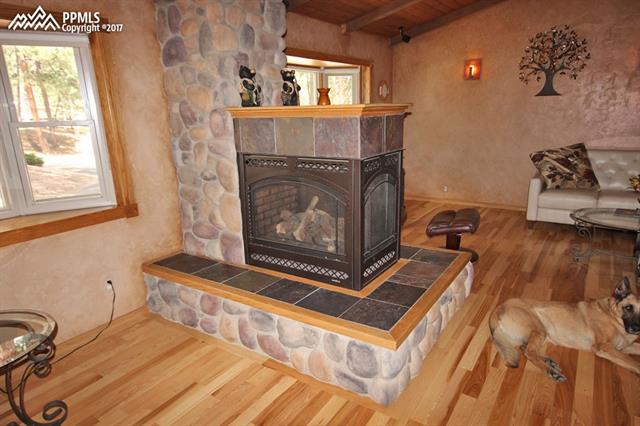 3415 Arena Road Colorado Springs, CO 80921 - Photo 3 of 36 Living Room/Family Room Separated by 3 Way Gas Fireplace,.. Look at those Hickory Floors
