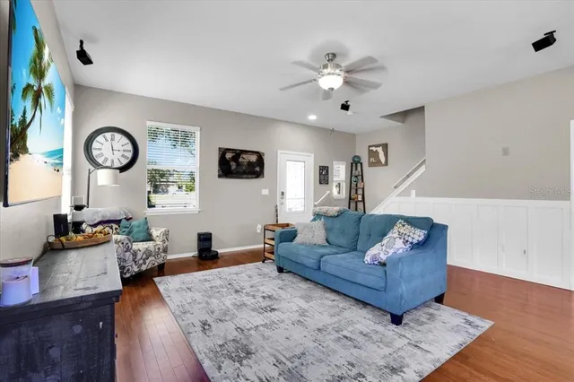a living room with furniture and wooden floor