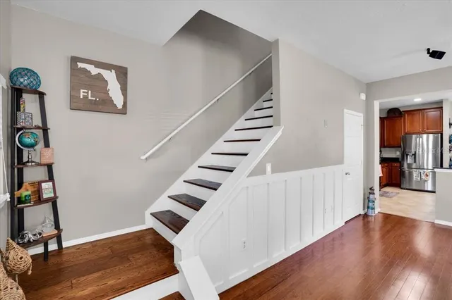 a view of entryway and hall with wooden floor