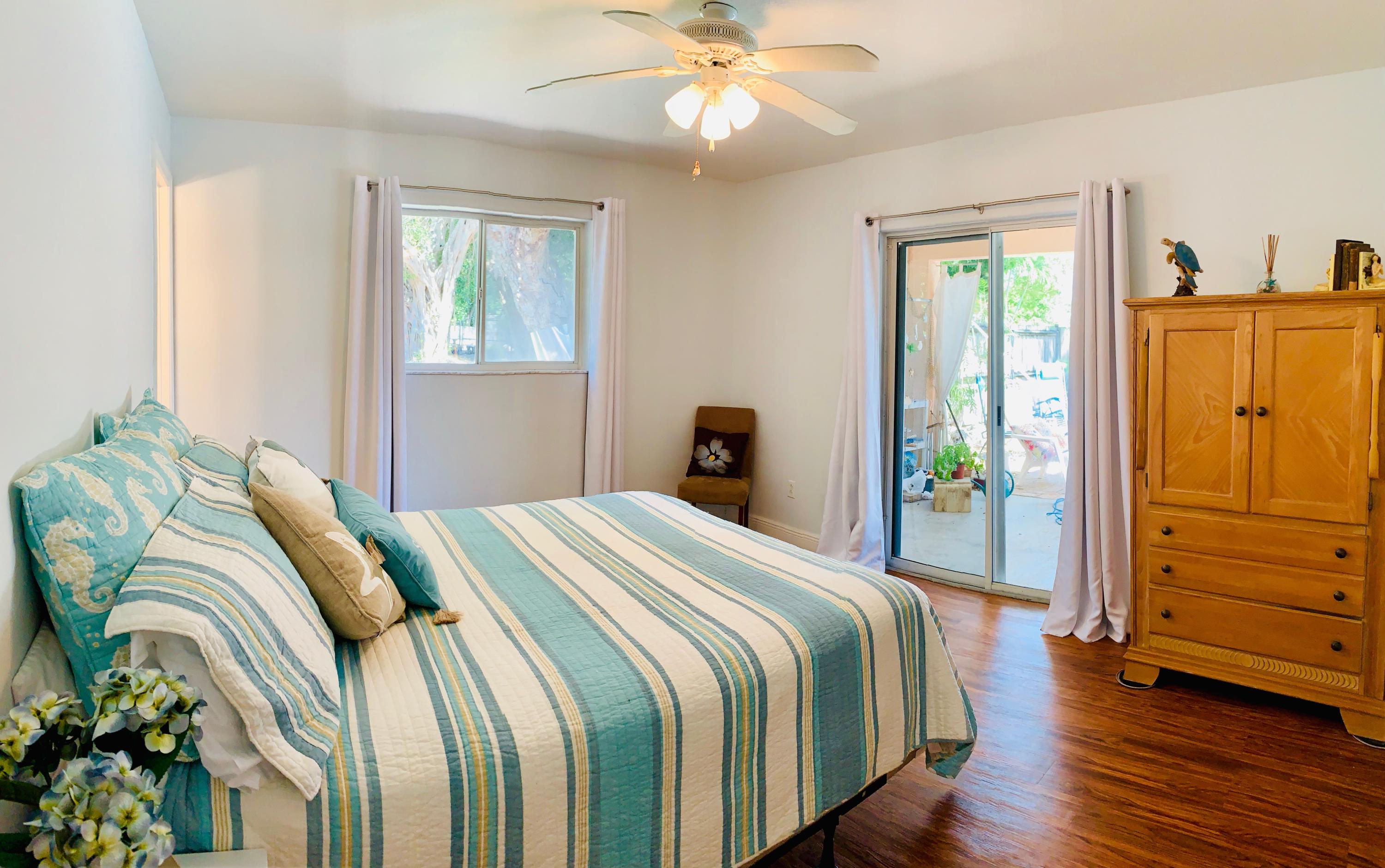 46 Snapper Avenue Key Largo, FL 33037 - Photo 11 of 26 a bedroom with a bed and wooden floor