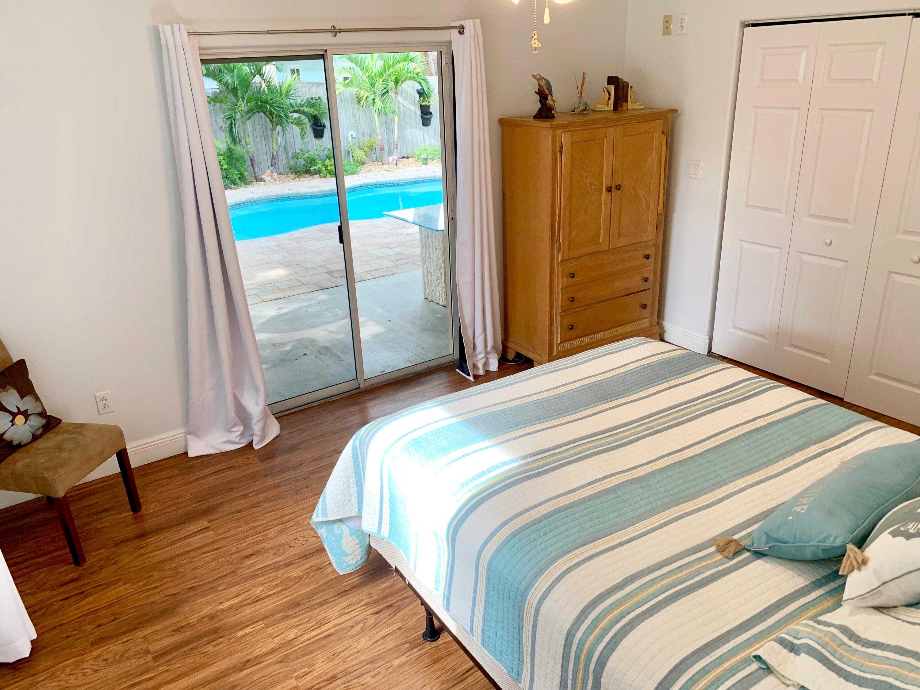 46 Snapper Avenue Key Largo, FL 33037 - Photo 12 of 26 a bedroom with a bed and wooden floor