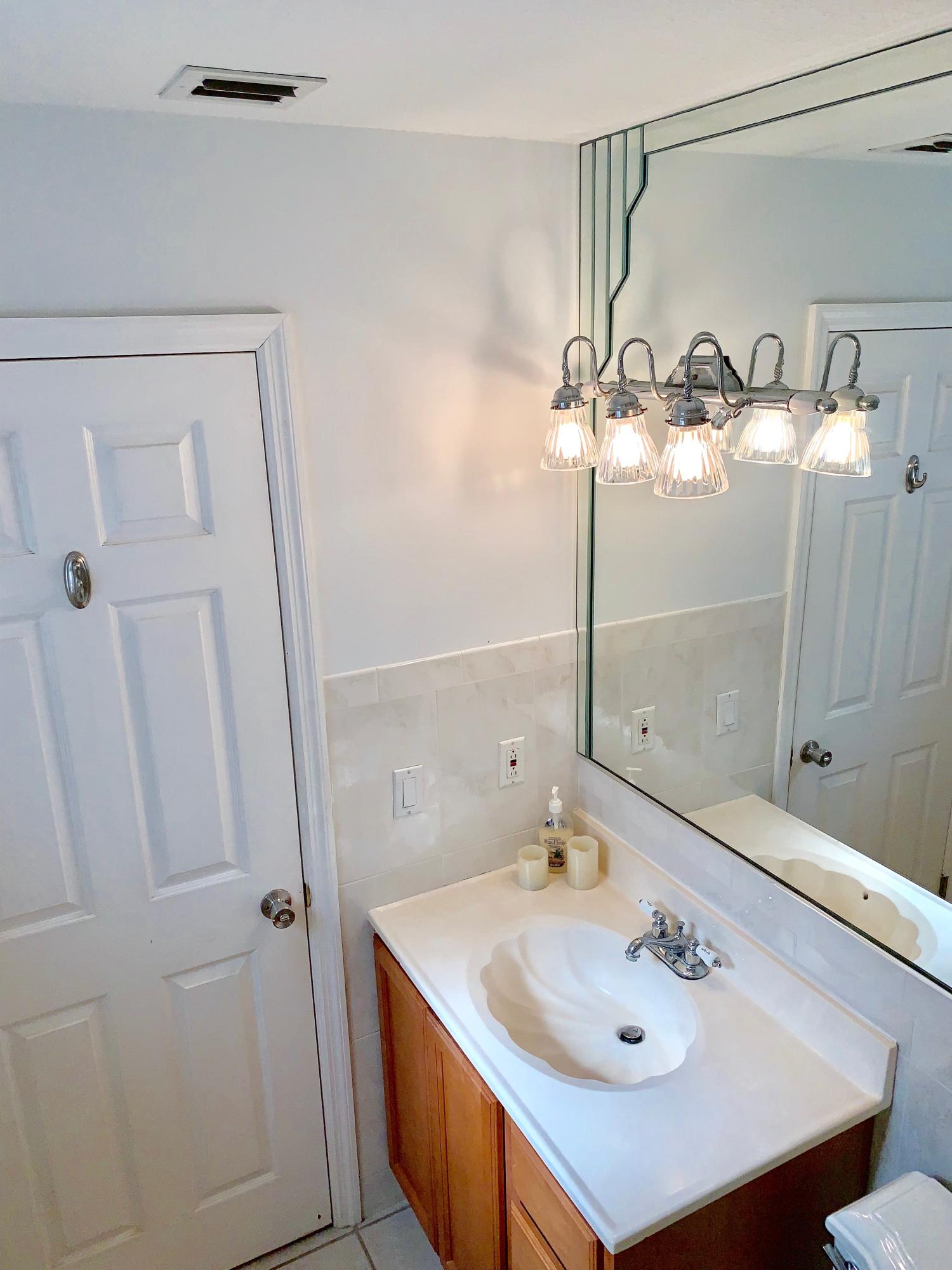 46 Snapper Avenue Key Largo, FL 33037 - Photo 14 of 26 a bathroom with a sink a mirror and a shower