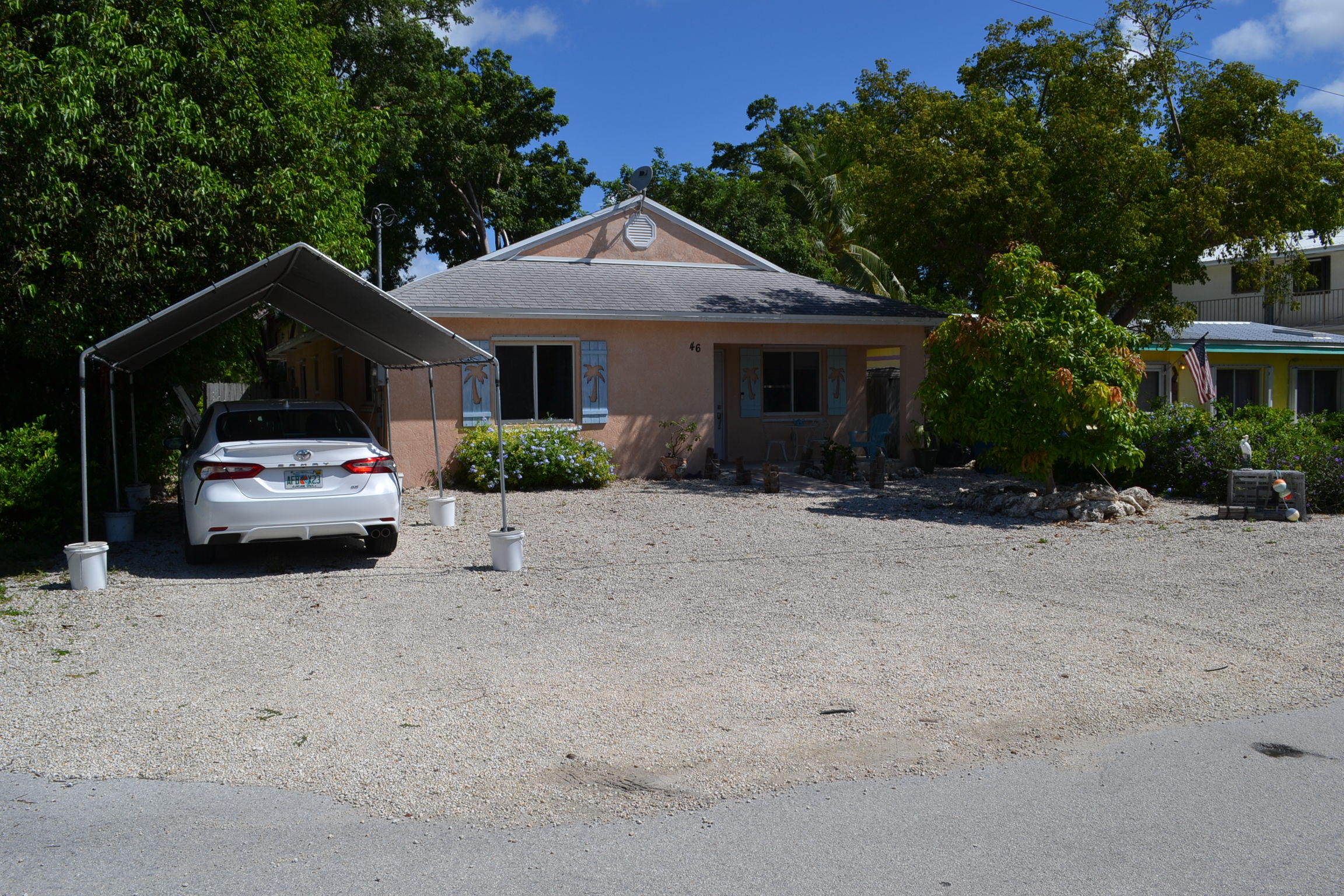 46 Snapper Avenue Key Largo, FL 33037 - Photo 2 of 26 a front view of a house with a yard and garage