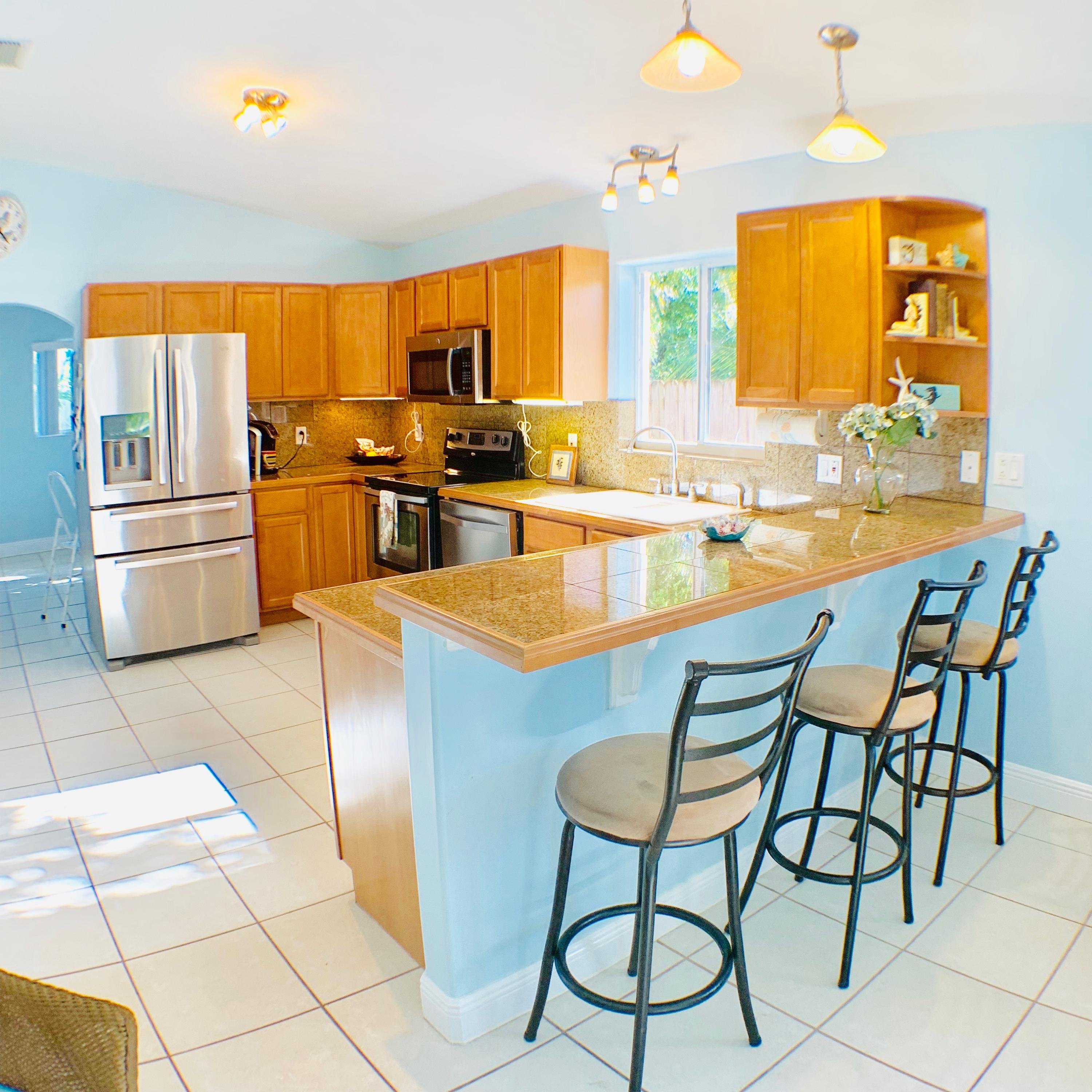 46 Snapper Avenue Key Largo, FL 33037 - Photo 5 of 26 a kitchen with stainless steel appliances granite countertop a stove a sink and a refrigerator