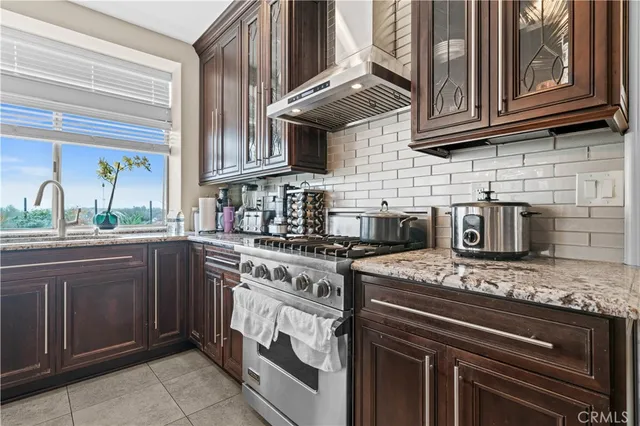 a kitchen with stainless steel appliances granite countertop a stove and a sink