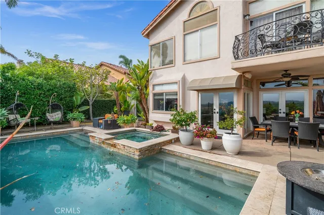 a view of a house with swimming pool and sitting area