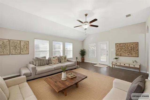 a living room with furniture and a large window
