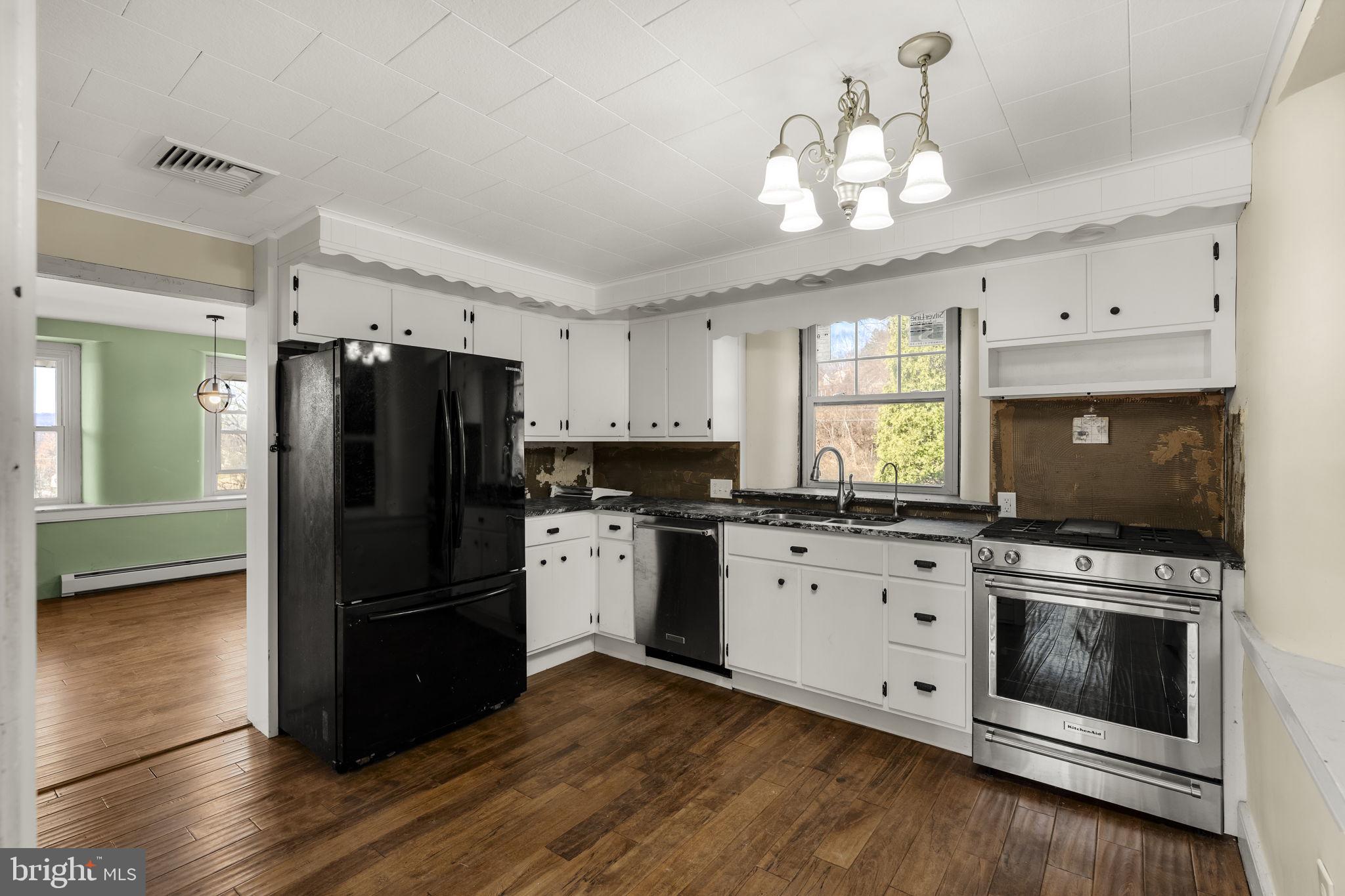39 Gill Road Mohnton, PA 19540 - Photo 11 of 59 a kitchen with granite countertop a refrigerator a stove a microwave and cabinets