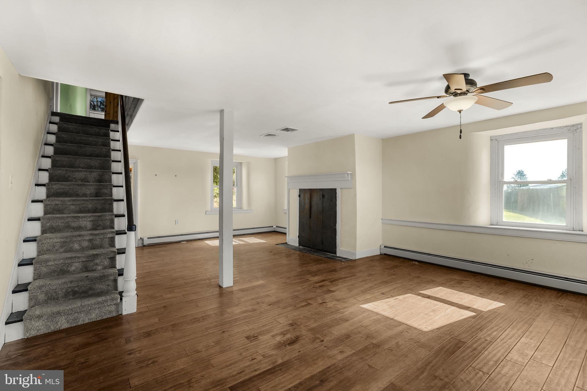 39 Gill Road Mohnton, PA 19540 - Photo 6 of 59 a view of an empty room with a fireplace and wooden floor