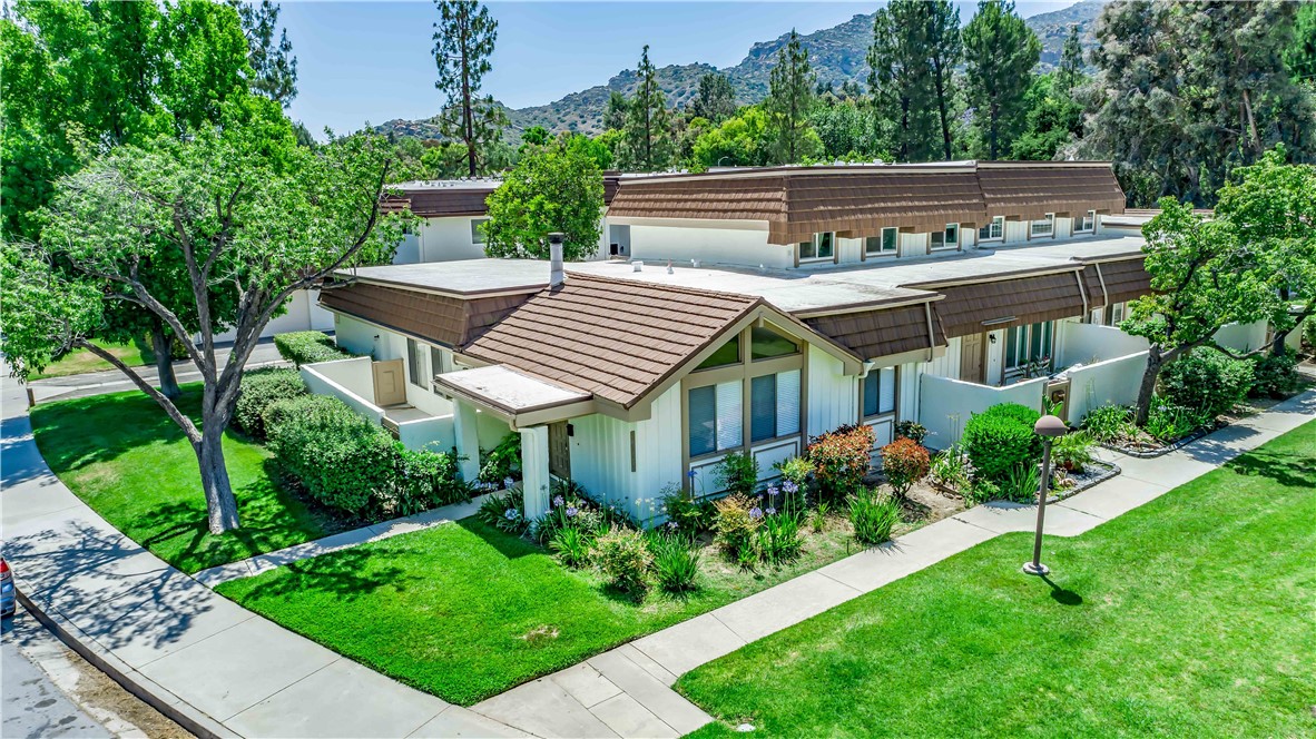 a view of a house with a chairs in a patio