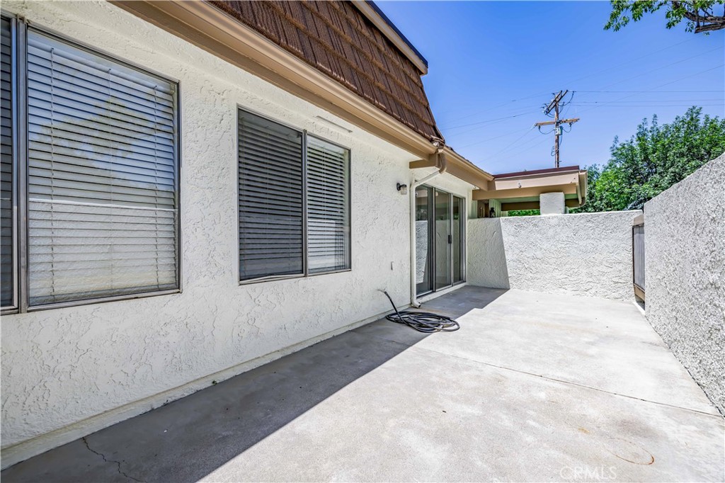 10215 Larwin Avenue, Unit 4 Chatsworth, CA 91311 - Photo 13 of 38 a white house with a yard and a outdoor space