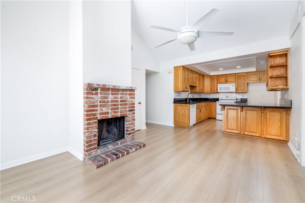 10215 Larwin Avenue, Unit 4 Chatsworth, CA 91311 - Photo 14 of 38 a view of kitchen with microwave a stove and wooden floor