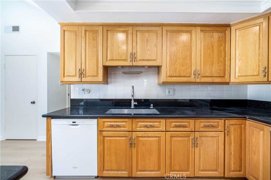 10215 Larwin Avenue, Unit 4 Chatsworth, CA 91311 - Photo 18 of 38 a kitchen with granite countertop cabinets and window