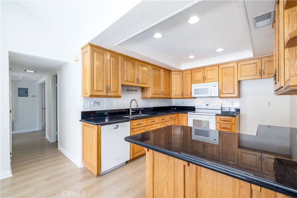 10215 Larwin Avenue, Unit 4 Chatsworth, CA 91311 - Photo 19 of 38 a kitchen with stainless steel appliances granite countertop sink stove and refrigerator