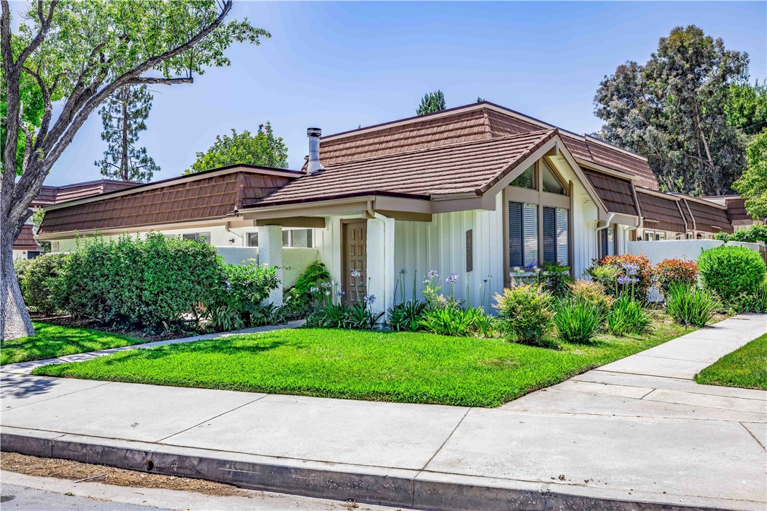 10215 Larwin Avenue, Unit 4 Chatsworth, CA 91311 - Photo 2 of 38 a front view of a house with a yard