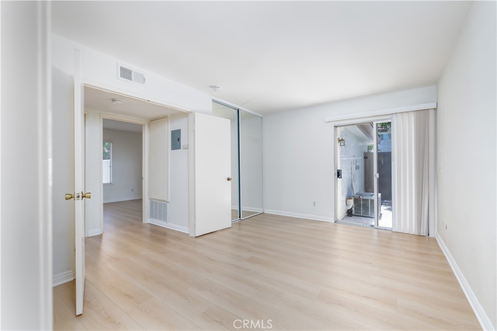 10215 Larwin Avenue, Unit 4 Chatsworth, CA 91311 - Photo 28 of 38 a view of an empty room with wooden floor