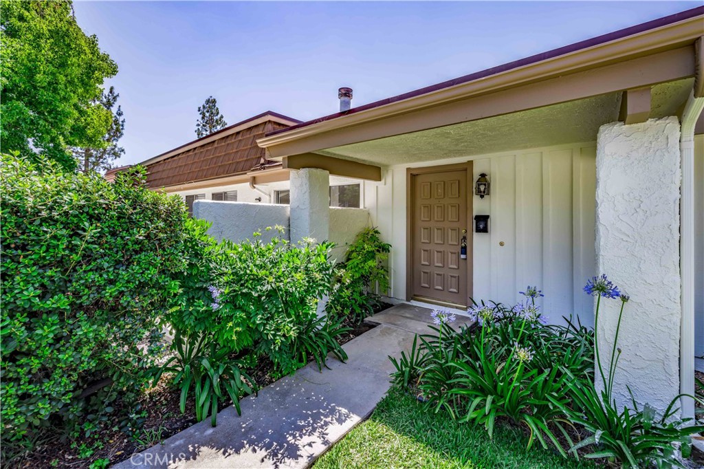 10215 Larwin Avenue, Unit 4 Chatsworth, CA 91311 - Photo 4 of 38 a view of a house with potted plants