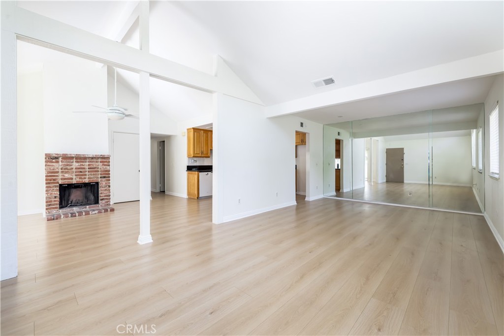 10215 Larwin Avenue, Unit 4 Chatsworth, CA 91311 - Photo 9 of 38 a view of a livingroom with wooden floor and a fireplace