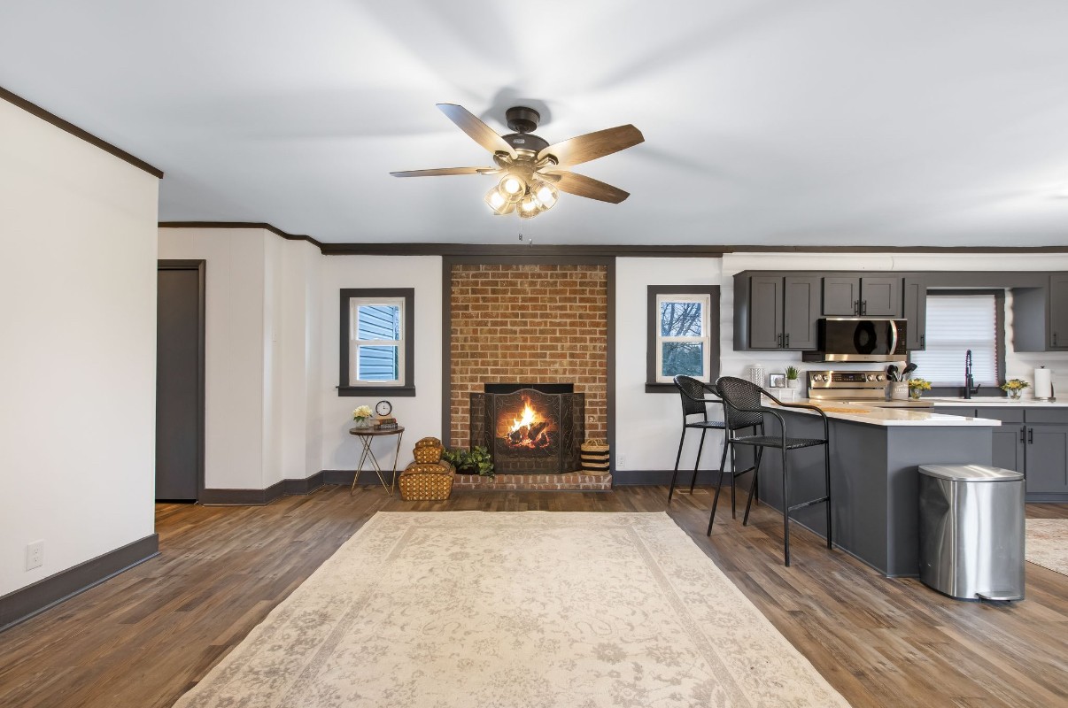 679 Alsup Mill Road Lebanon, TN 37090 - Photo 7 of 26 a living room with furniture a fireplace and kitchen view