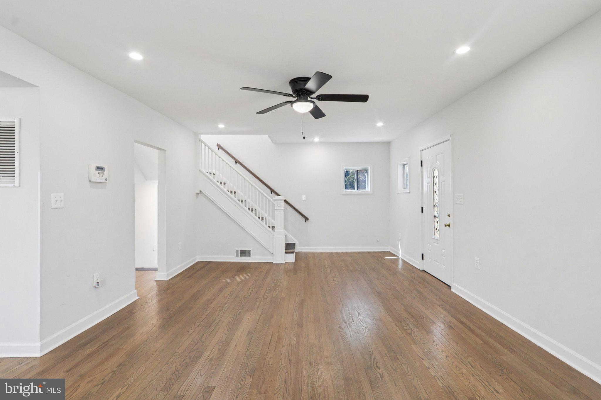 4357 Southern Avenue Southeast Capitol Heights, MD 20743 - Photo 11 of 84 an empty room with wooden floor ceiling fan and windows