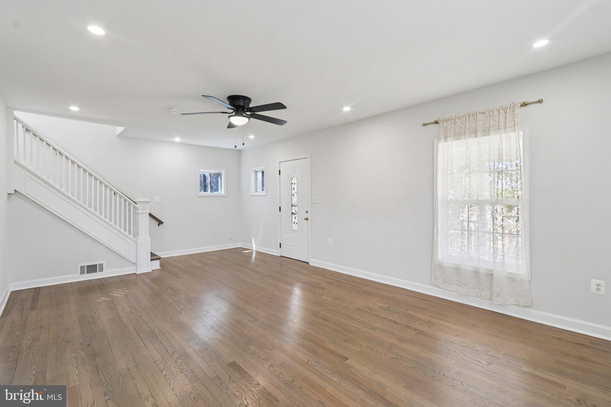 4357 Southern Avenue Southeast Capitol Heights, MD 20743 - Photo 12 of 84 a view of an empty room with wooden floor and a ceiling fan