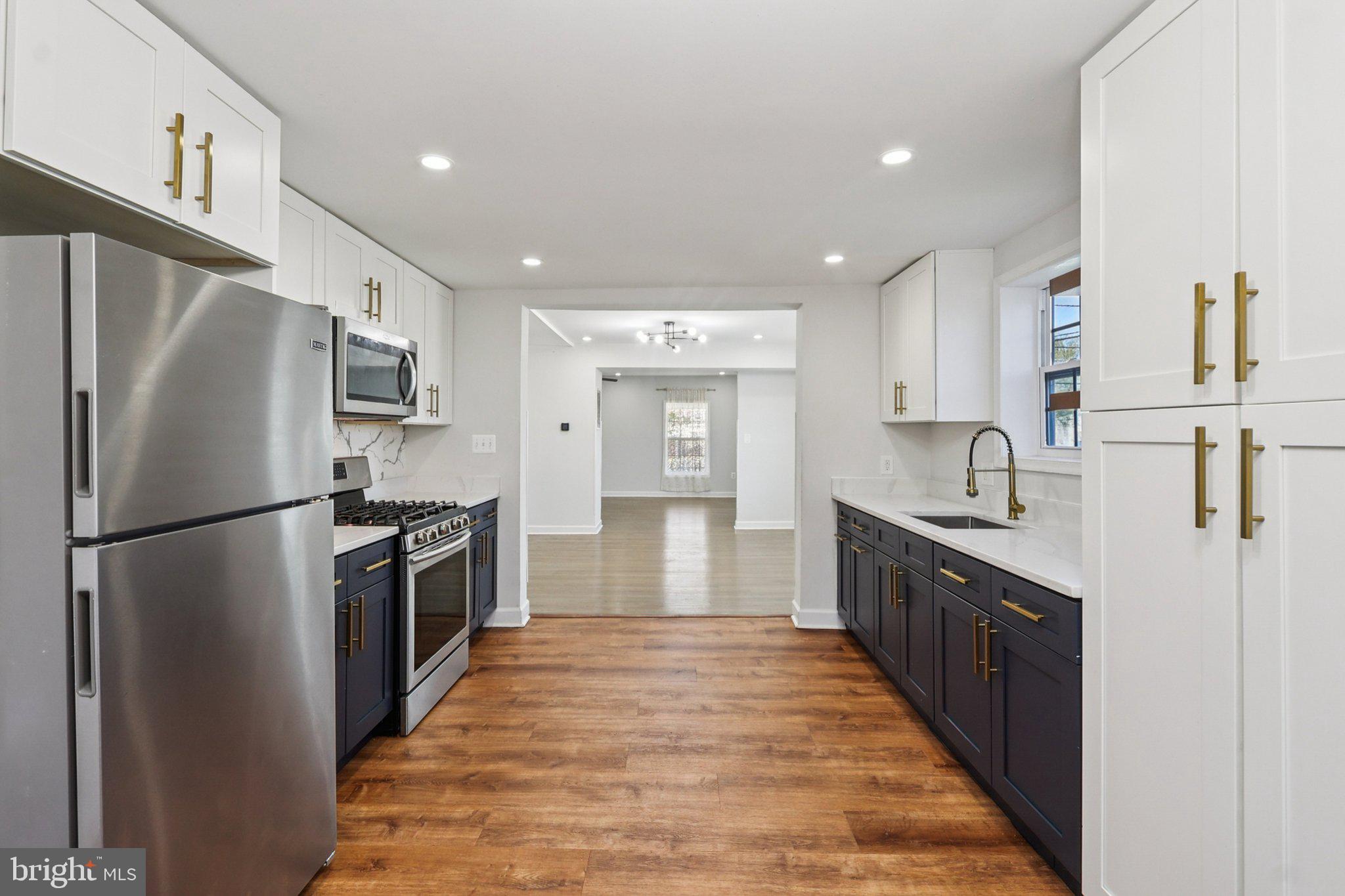 4357 Southern Avenue Southeast Capitol Heights, MD 20743 - Photo 27 of 84 a large kitchen with stainless steel appliances a refrigerator and a sink
