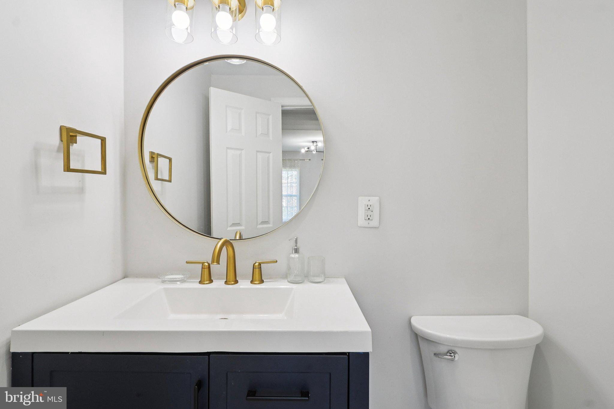 4357 Southern Avenue Southeast Capitol Heights, MD 20743 - Photo 28 of 84 a bathroom with a sink a mirror and a toilet