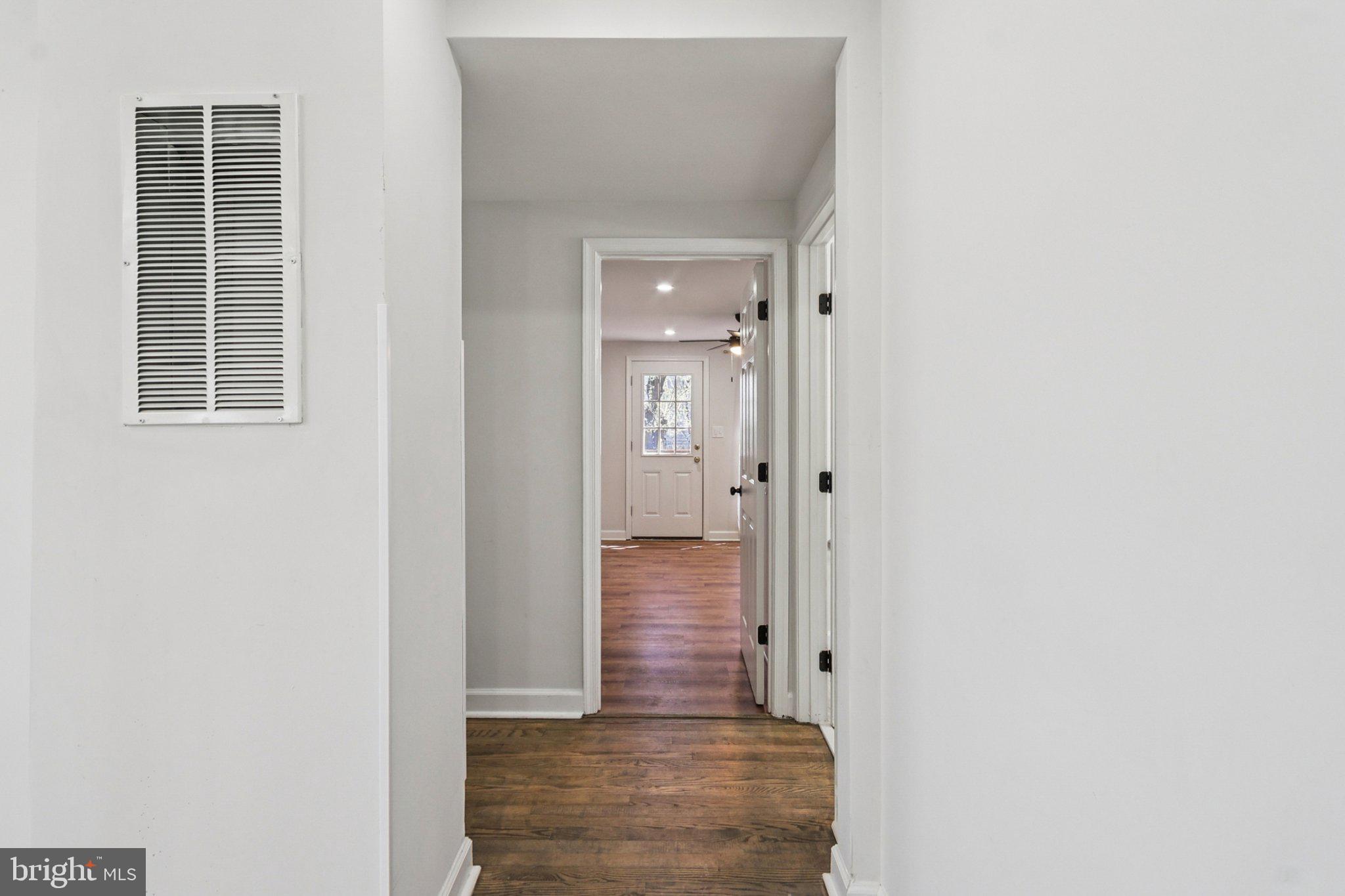4357 Southern Avenue Southeast Capitol Heights, MD 20743 - Photo 29 of 84 a view of a hallway with wooden floor and a bathroom