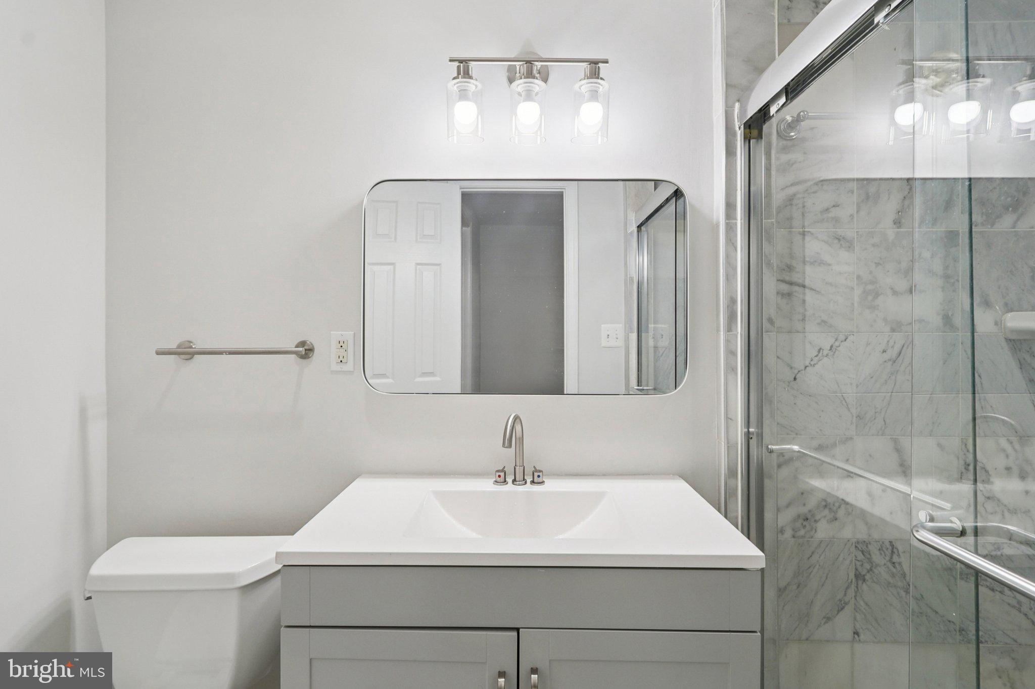 4357 Southern Avenue Southeast Capitol Heights, MD 20743 - Photo 30 of 84 a bathroom with a sink a toilet and shower