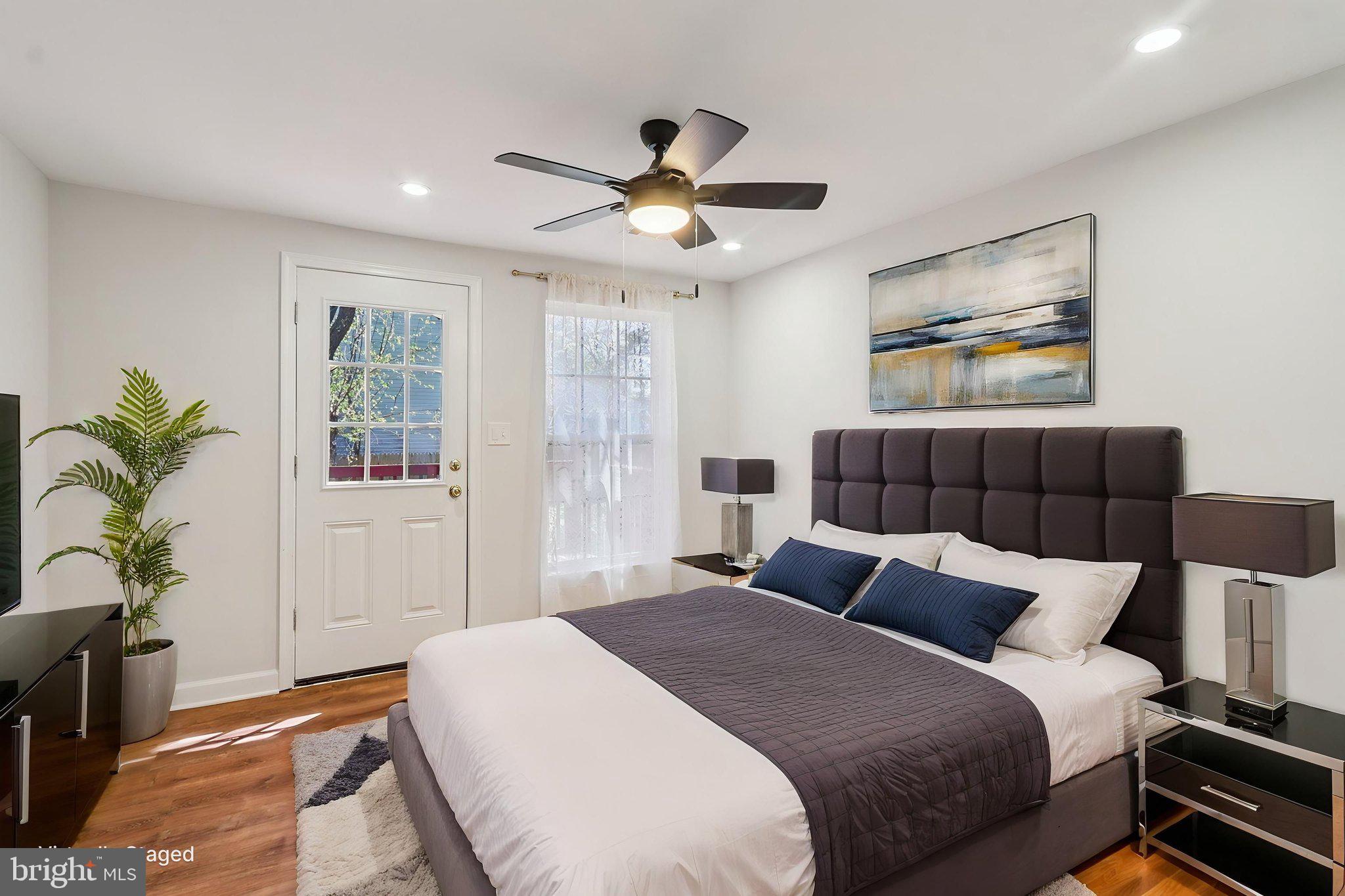 4357 Southern Avenue Southeast Capitol Heights, MD 20743 - Photo 33 of 84 a bedroom with a large bed and a chandelier