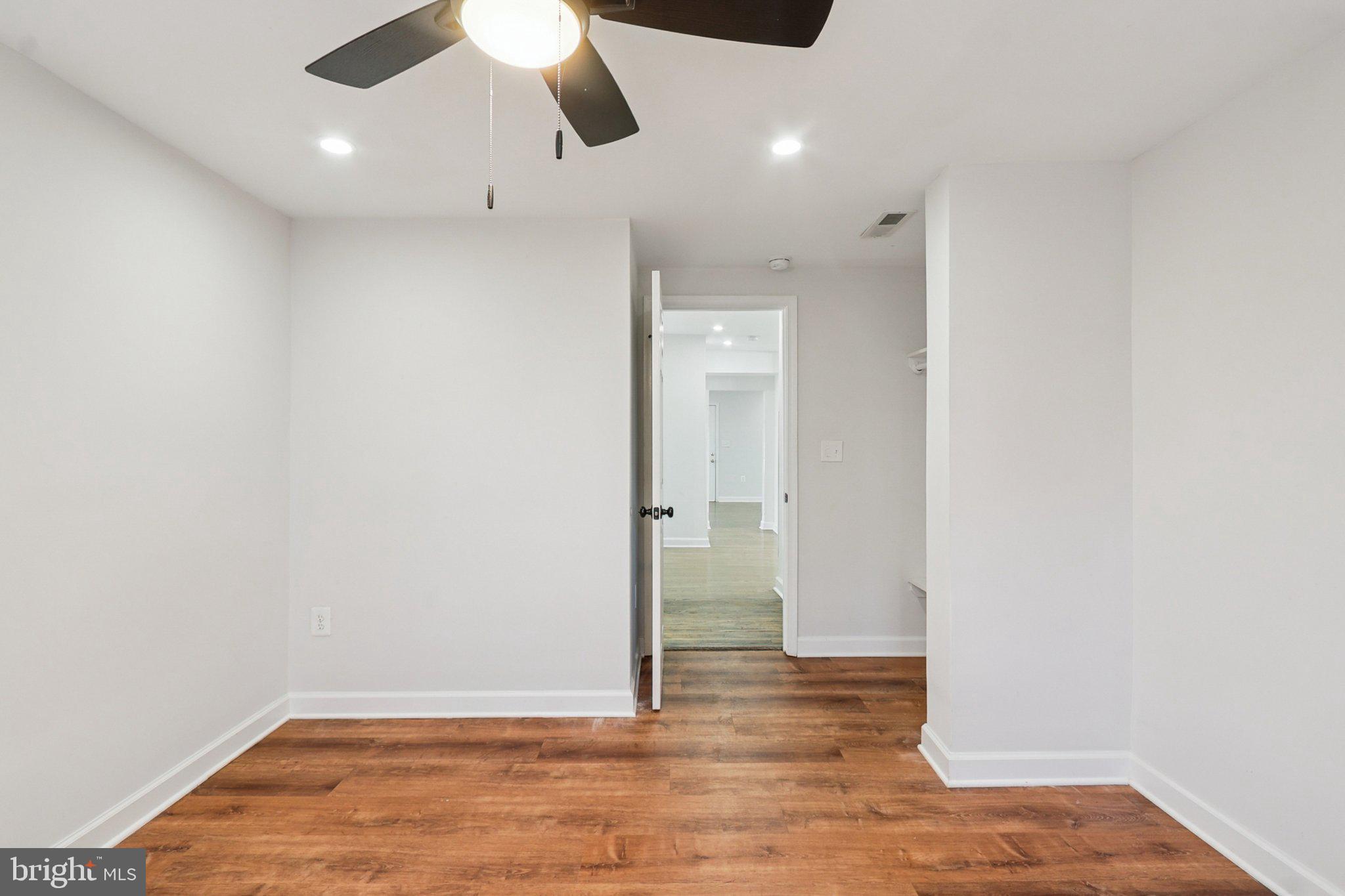 4357 Southern Avenue Southeast Capitol Heights, MD 20743 - Photo 36 of 84 an empty room with wooden floor ceiling fan and window