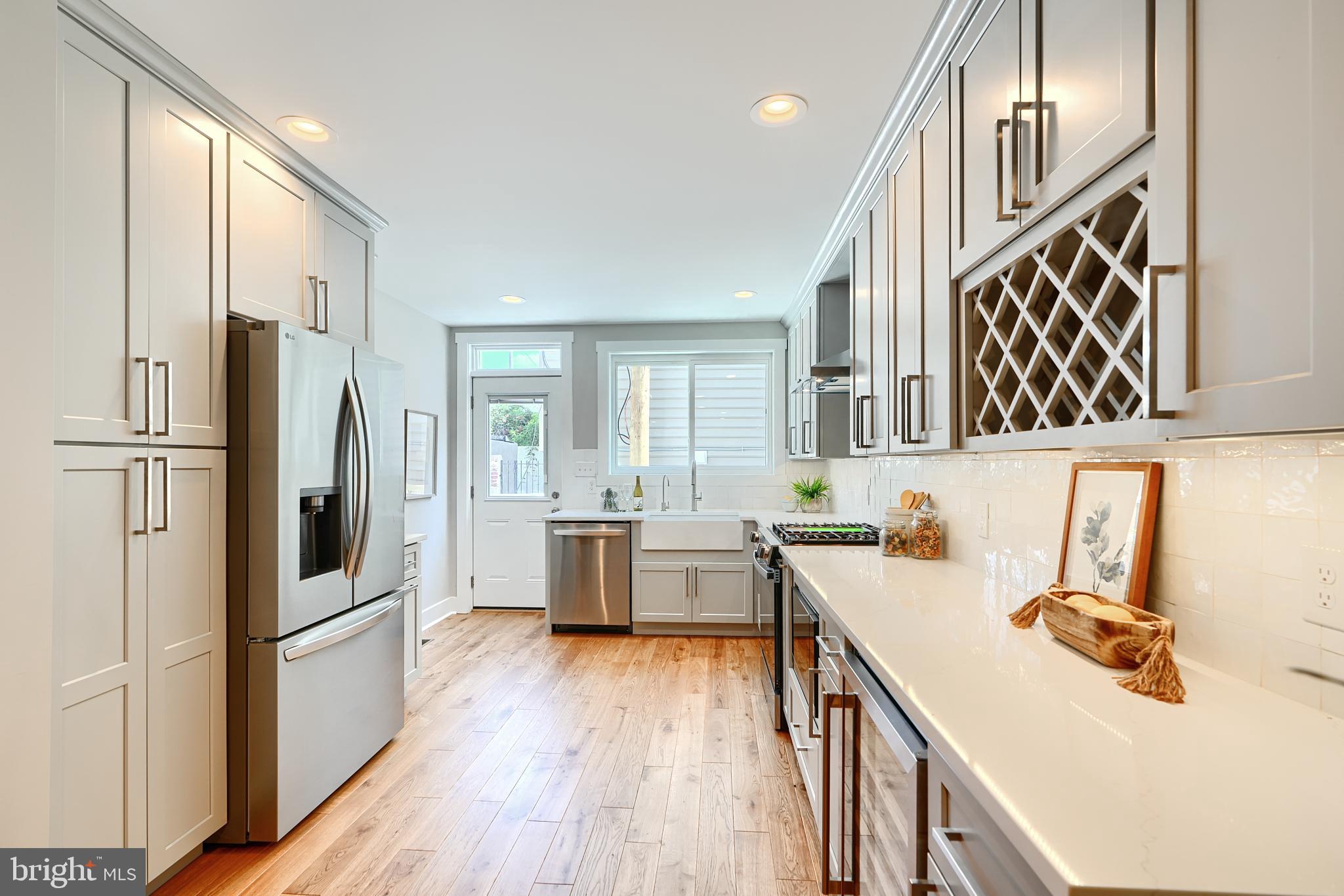 3029 Hudson Street Baltimore, MD 21224 - Photo 15 of 52 a kitchen with a refrigerator a sink and dishwasher a oven with wooden floor