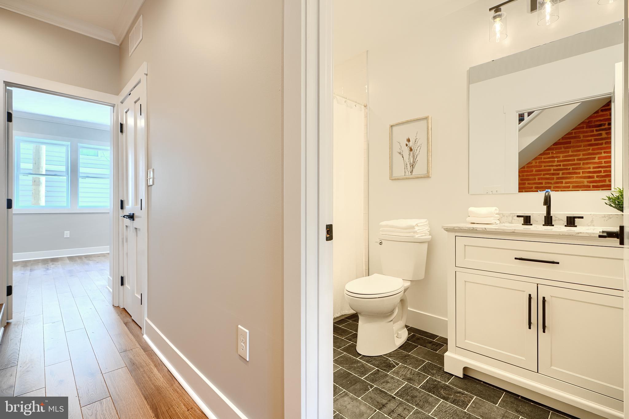3029 Hudson Street Baltimore, MD 21224 - Photo 21 of 52 a bathroom with a granite countertop sink toilet and shower
