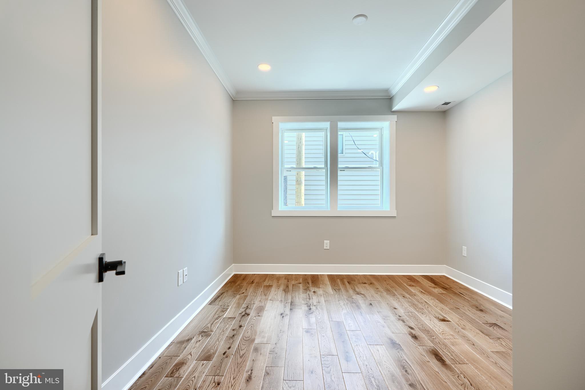 3029 Hudson Street Baltimore, MD 21224 - Photo 24 of 52 an empty room with wooden floor and windows