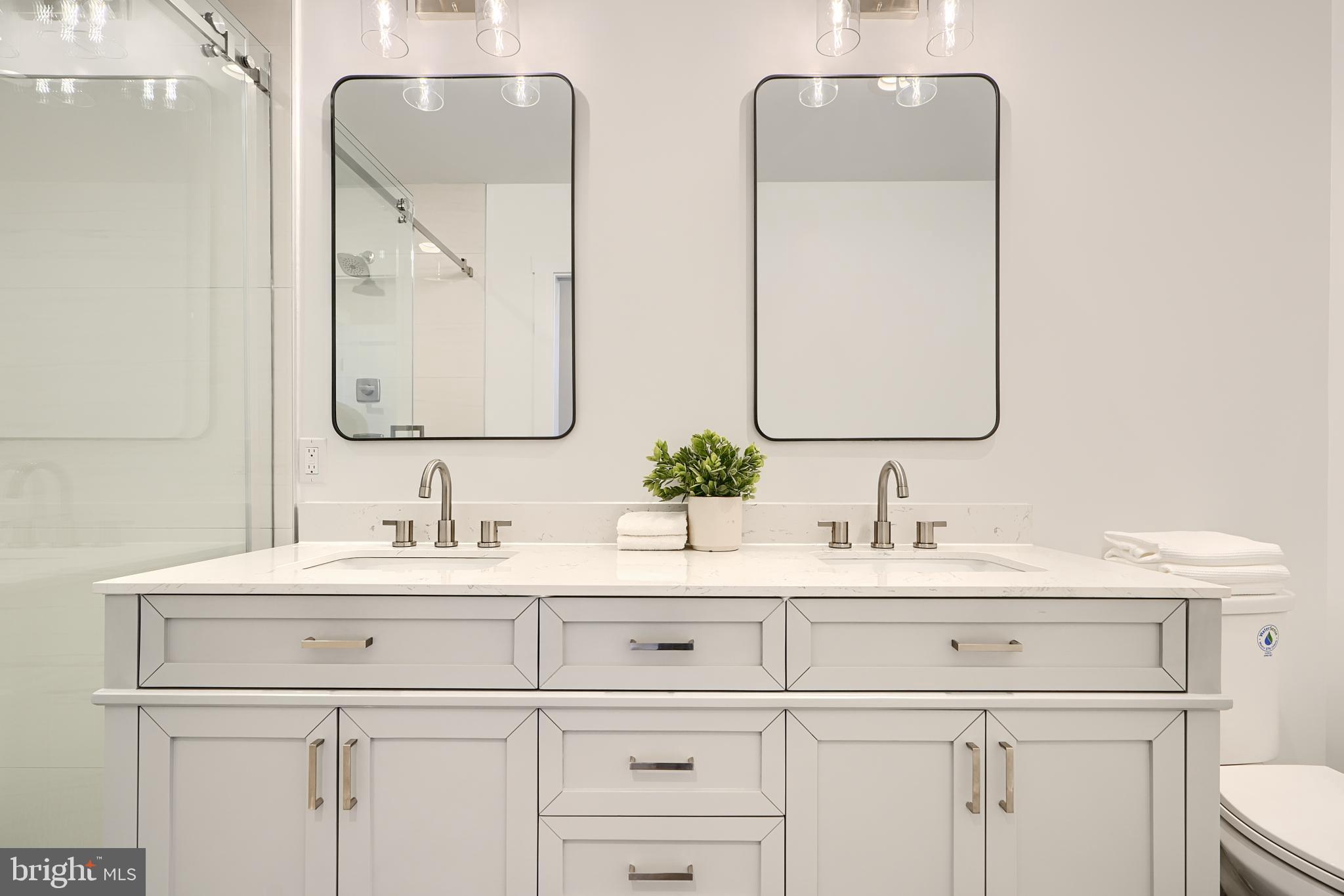3029 Hudson Street Baltimore, MD 21224 - Photo 29 of 52 a bathroom with double vanity sink a mirror and
