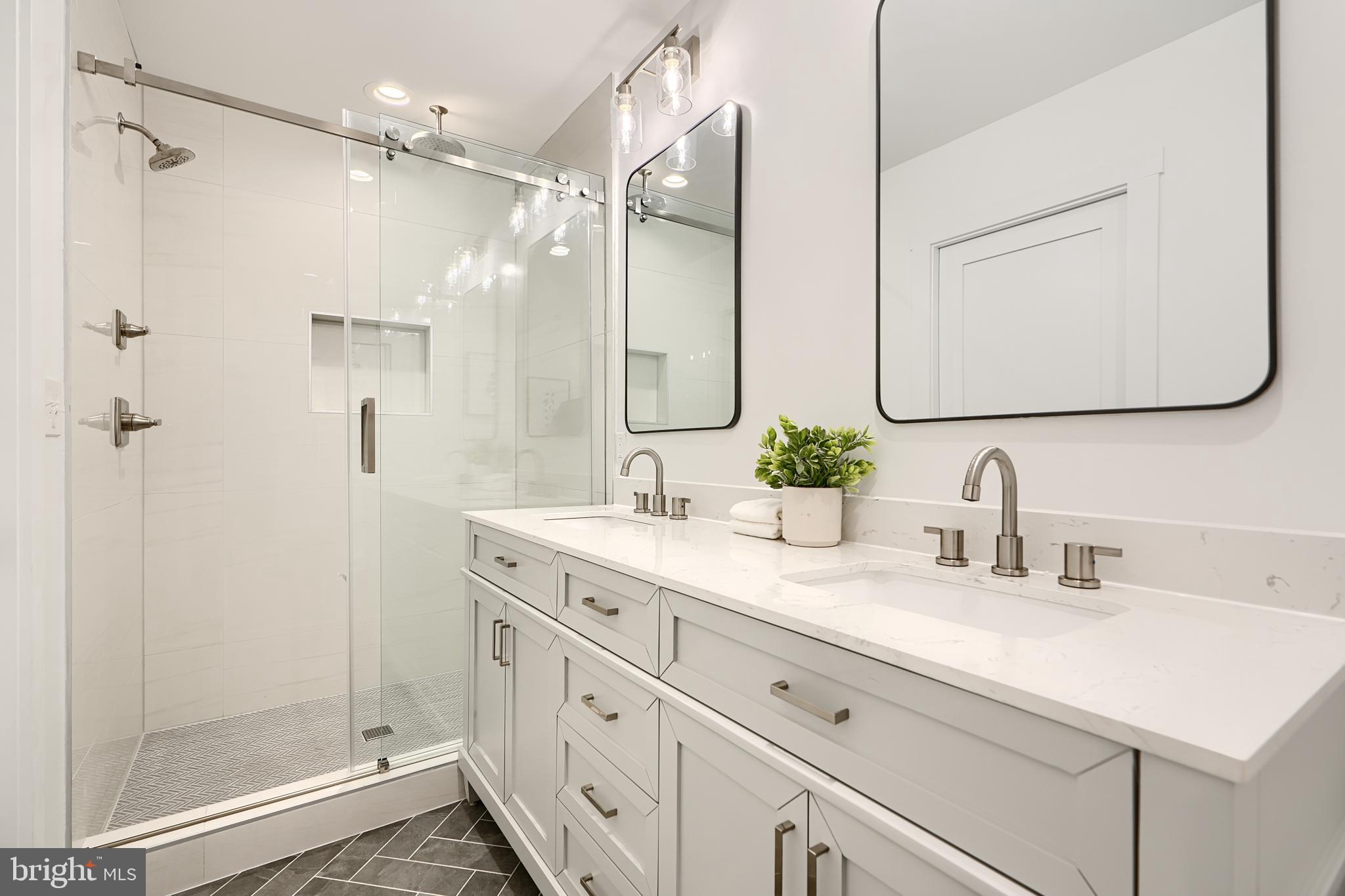 3029 Hudson Street Baltimore, MD 21224 - Photo 30 of 52 a bathroom with a double vanity sink mirror and shower