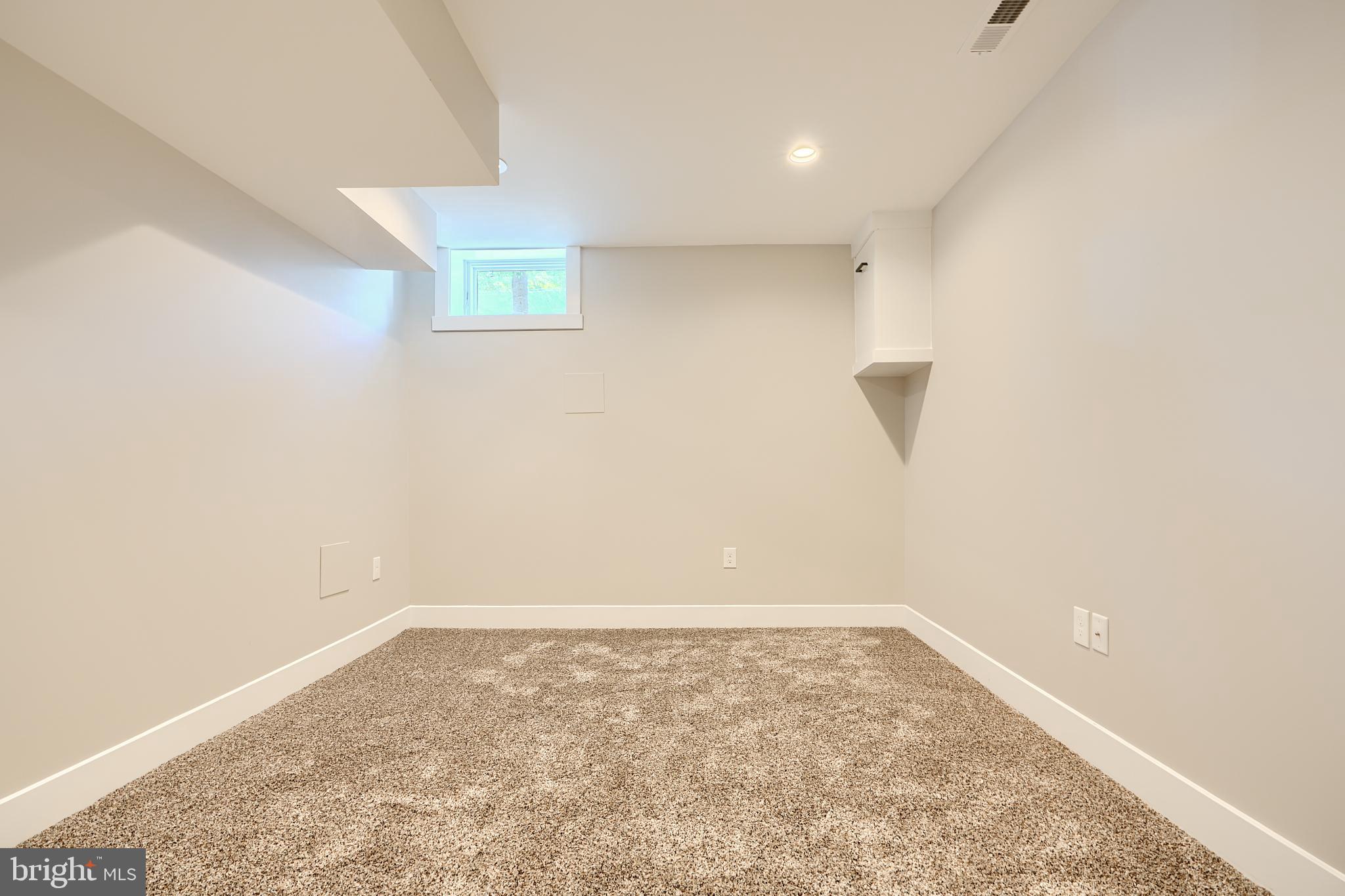 3029 Hudson Street Baltimore, MD 21224 - Photo 45 of 52 an empty room with a ceiling fan and window