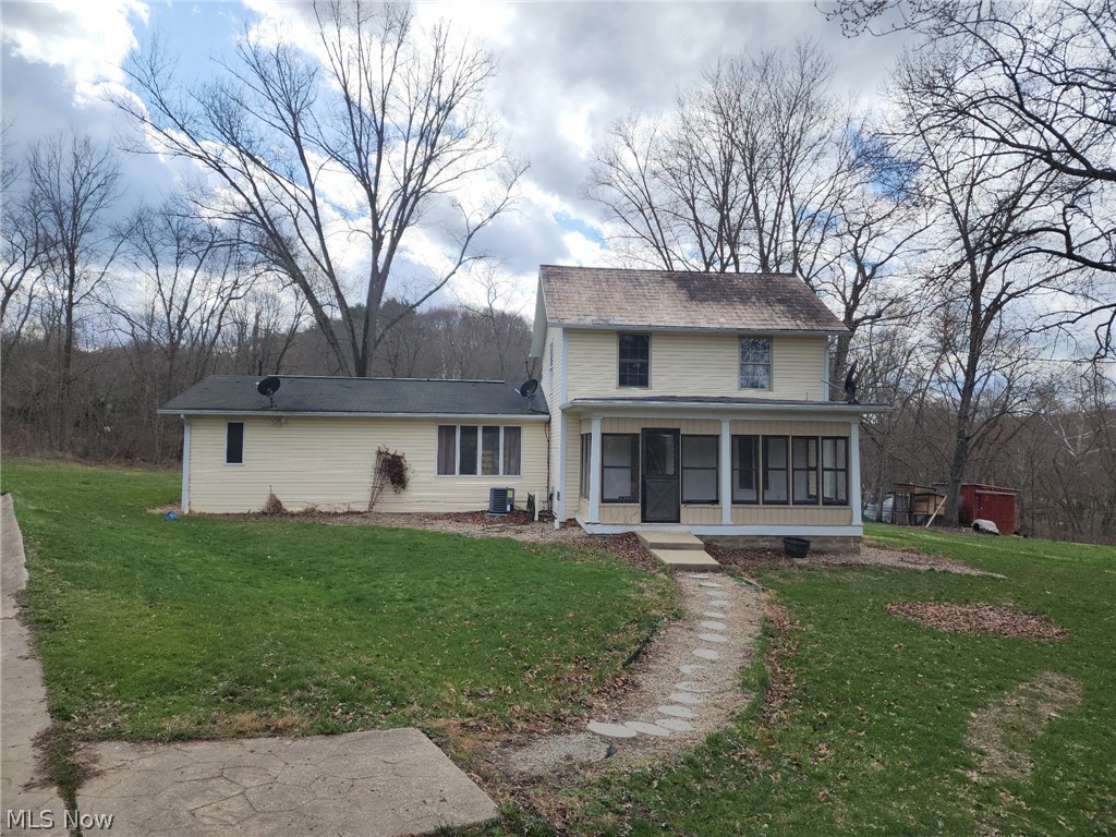 6784 Old Zoarville Road Northeast Dover, OH 44622 - Photo 50 of 50 View of front facade with a sunroom and a front yard
