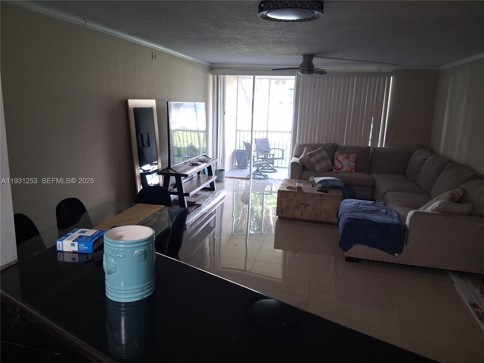 1750 Northeast 191st Street, Unit 1041 Miami, FL 33179 - Photo 11 of 17 a living room with furniture and a window