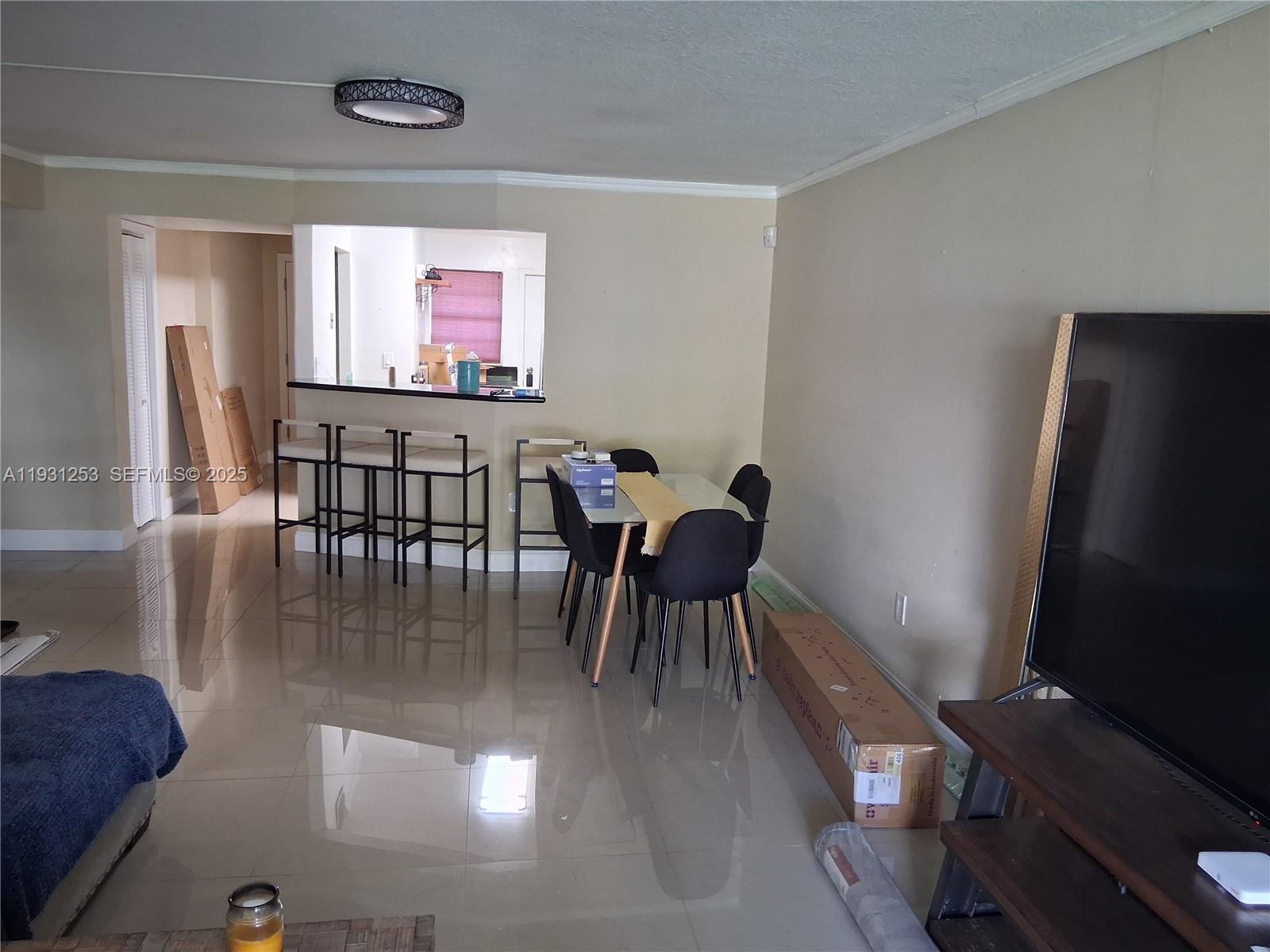 1750 Northeast 191st Street, Unit 1041 Miami, FL 33179 - Photo 16 of 17 a dining room with furniture and window